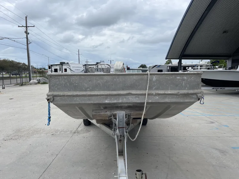Slide: The Image of 1991 Custom 18ft boat on trailer in outdoor storage area. - 3