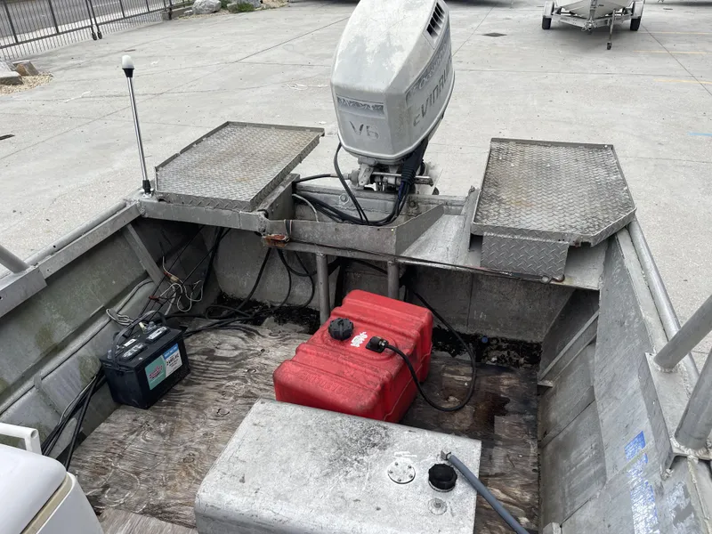 Slide: The Image of 1991 Custom 18ft boat interior with Evinrude motor, battery, and red fuel tank. - 5