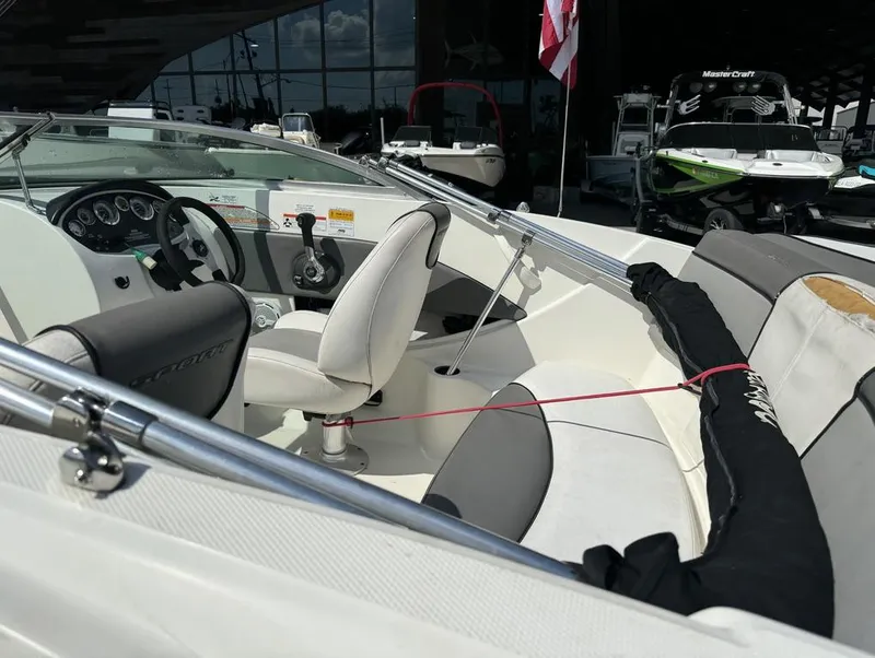 Slide: The Image of Interior of a 2011 Sea Ray 185 Sport boat, featuring steering wheel and seating. - 10