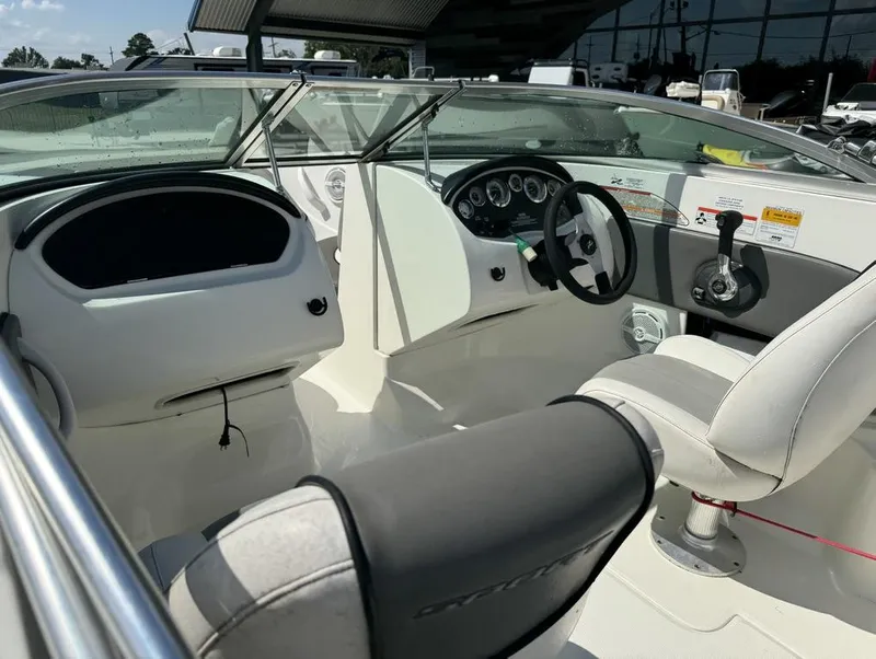 Slide: The Image of Interior of a 2011 Sea Ray 185 Sport boat, featuring steering wheel and dashboard controls. - 14