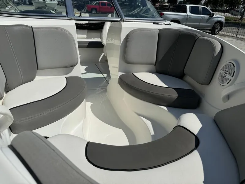 Slide: The Image of Interior seating of a 2011 Sea Ray 185 Sport boat, featuring gray and white upholstery. - 6