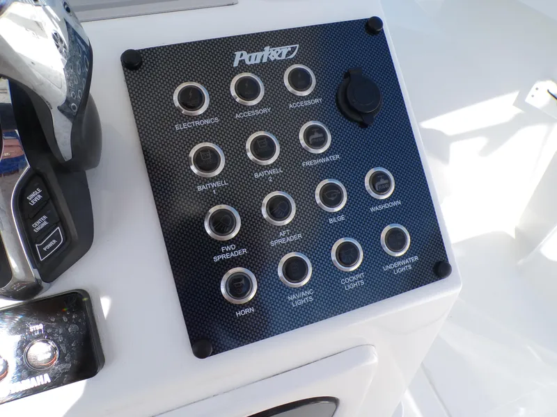 Slide: The Image of Control panel of 2024 Parker 2600 Center Console boat with labeled switches. - 12