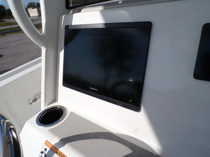 Slide: The Image of 2024 Parker 2600 Center Console boat dashboard with Garmin display and cup holder. - 14