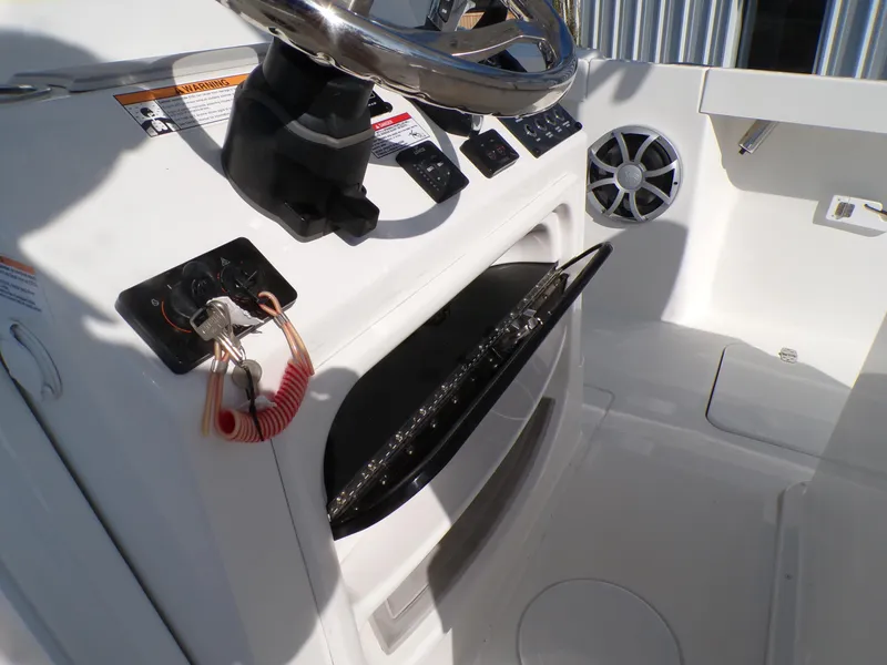 Slide: The Image of 2024 Parker 2600 Center Console boat interior with steering wheel and control panel. - 21
