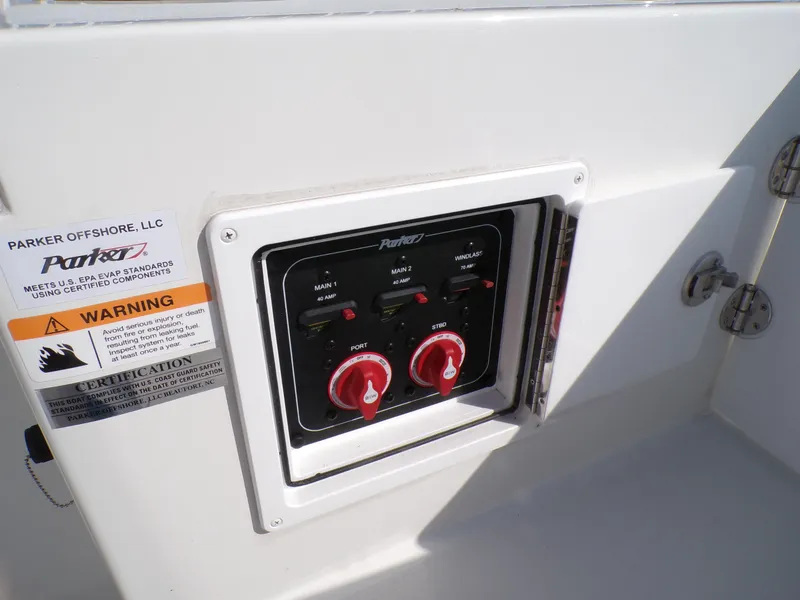 Slide: The Image of Control panel on 2024 Parker 2600 Center Console boat with warning labels. - 25