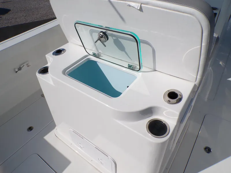 Slide: The Image of 2024 Parker 2600 Center Console boat with open storage compartment and cup holders. - 29