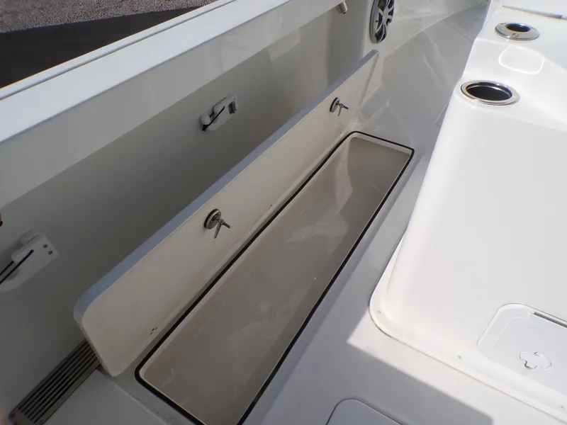 Slide: The Image of 2024 Parker 2600 Center Console boat interior with storage compartment and cup holders. - 34