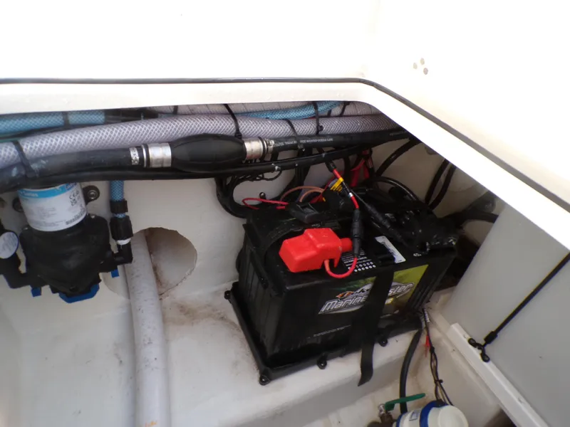 Slide: The Image of 2024 Parker 2600 Center Console boat battery compartment with wiring and components. - 35