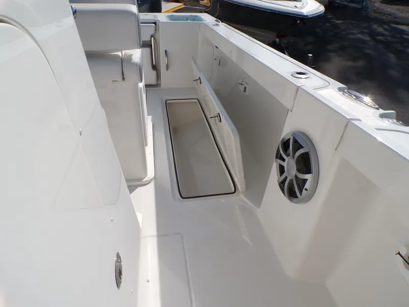 Slide: The Image of 2024 Parker 2600 Center Console boat interior with storage and speaker. - 36