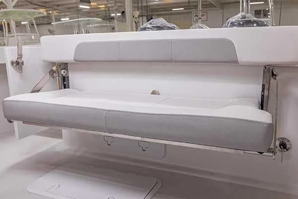 Slide: The Image of 2024 Parker 2600 Center Console boat with foldable seating in a factory setting. - 46