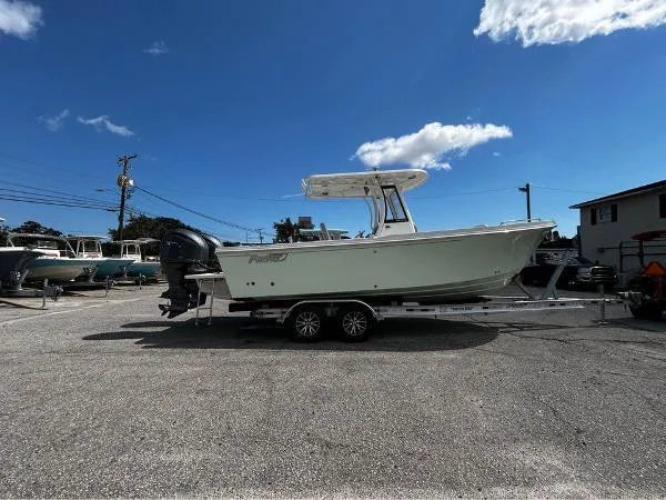 Slide: The Image of 2024 Parker 2600 Center Console boat on trailer under clear blue sky. - 49