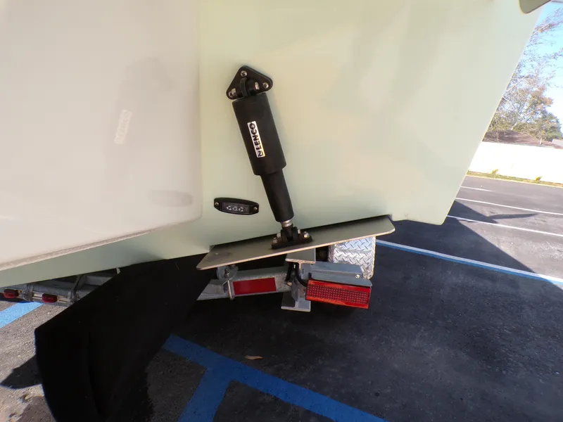 Slide: The Image of 2024 Parker 2600 Center Console boat trailer detail with trim tab and hydraulic actuator. - 7