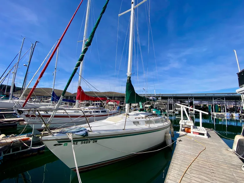 Slide: The Image of 1978 Catalina 30 sailboat docked at marina under clear blue sky. - 20