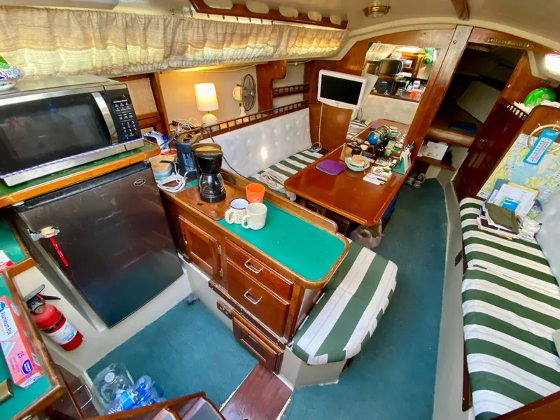 Slide: The Image of Interior of a 1978 Catalina 30 sailboat with kitchen and seating area. - 22