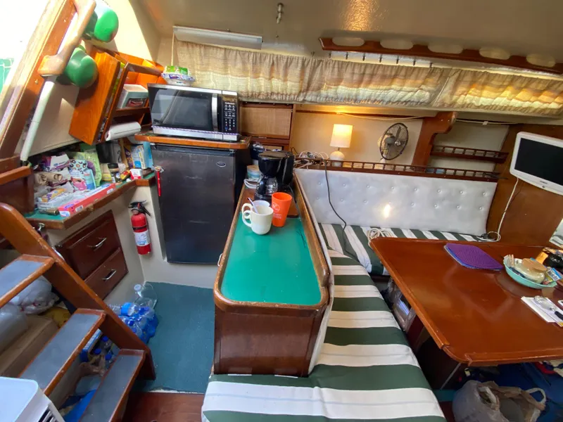 Slide: The Image of Interior of a 1978 Catalina 30 sailboat with kitchen and dining area. - 23
