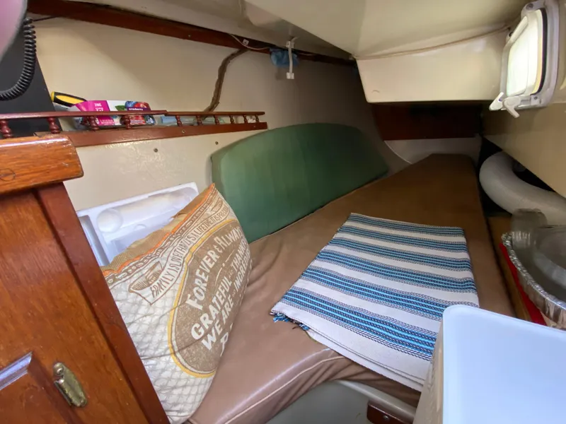 Slide: The Image of Cozy cabin interior of a 1978 Catalina 30 sailboat with bedding and storage. - 24