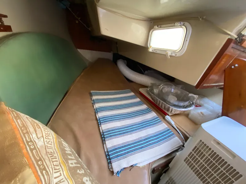 Slide: The Image of Interior of a 1978 Catalina 30 sailboat with a small cabin space. - 25