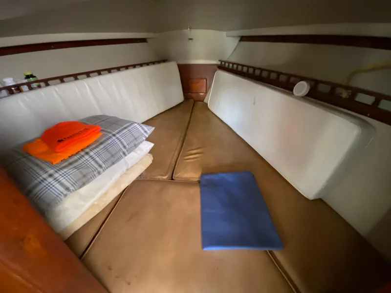 Slide: The Image of Interior cabin of a 1978 Catalina 30 sailboat with cushions and bedding. - 28
