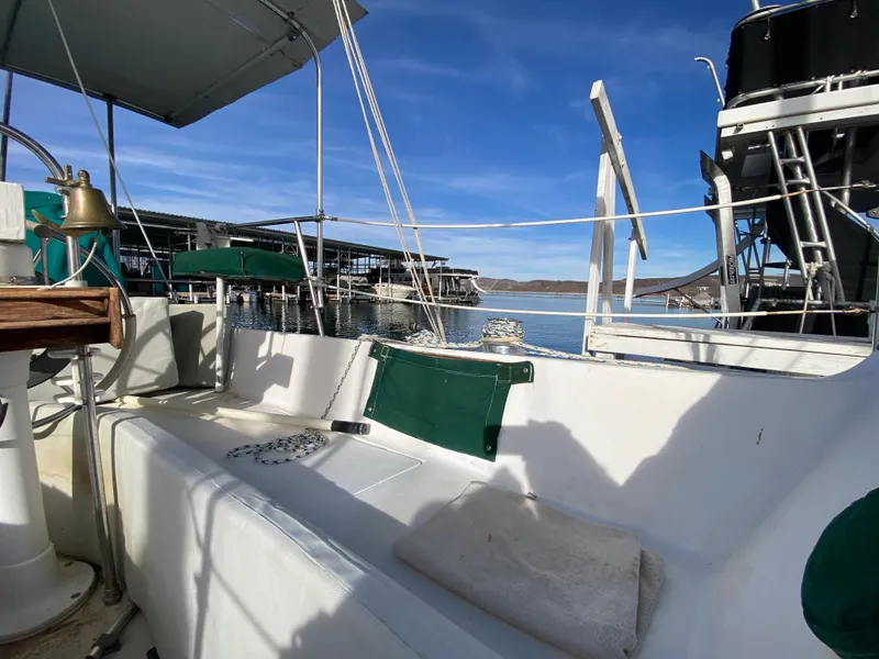Slide: The Image of 1978 Catalina 30 sailboat cockpit with marina view under clear blue sky. - 31