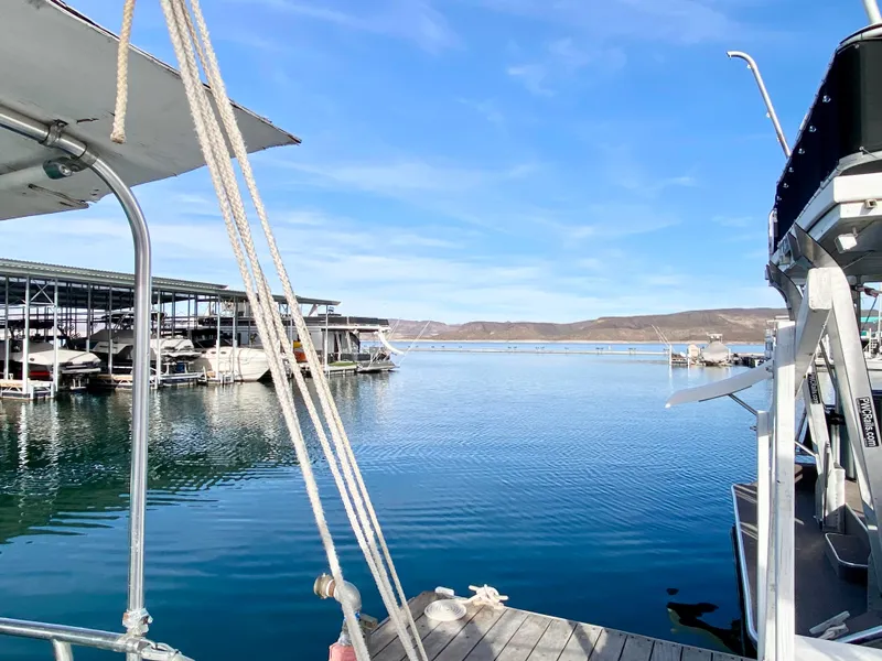 Slide: The Image of View from a 1978 Catalina 30 sailboat docked at a marina on a clear day. - 32