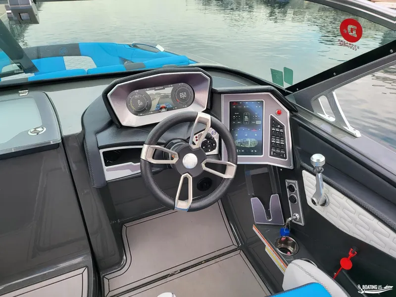 Slide: The Image of 2021 MasterCraft X26 boat dashboard with modern steering and digital controls. - 19