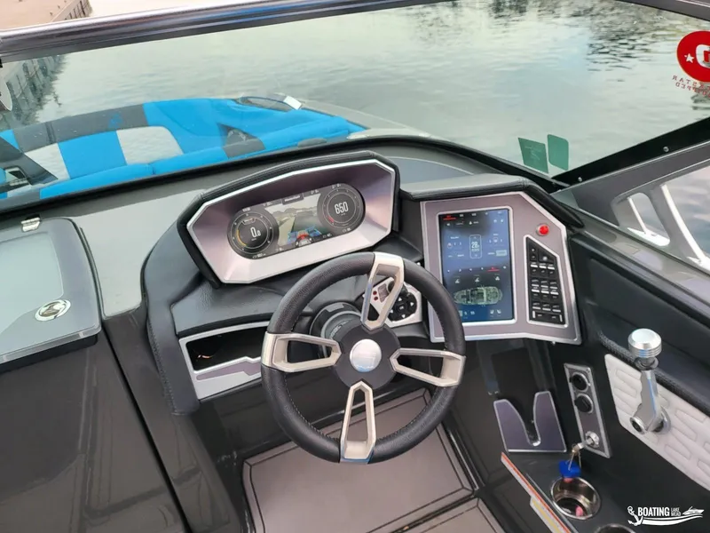 Slide: The Image of 2021 MasterCraft X26 boat dashboard with modern controls and steering wheel. - 21