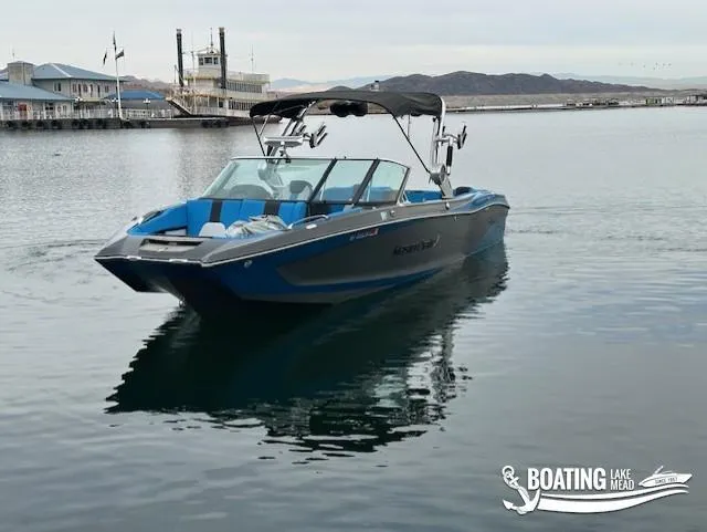 Slide: The Image of 2021 MasterCraft X26 boat on calm lake with distant mountains. - 3