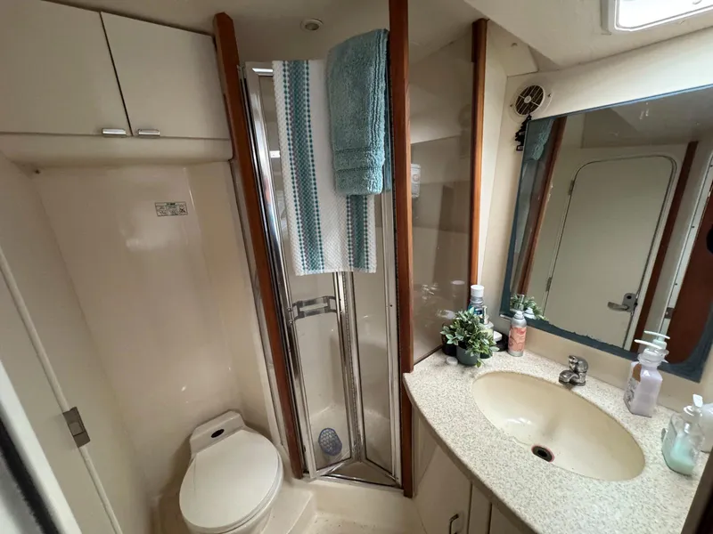 Slide: The Image of Bathroom interior of 1999 Luhrs 360 Convertible yacht with shower, sink, and toilet. - 18