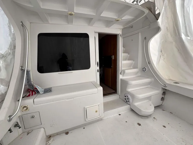 Slide: The Image of 1999 Luhrs 360 Convertible boat interior with stairs and seating area. - 2