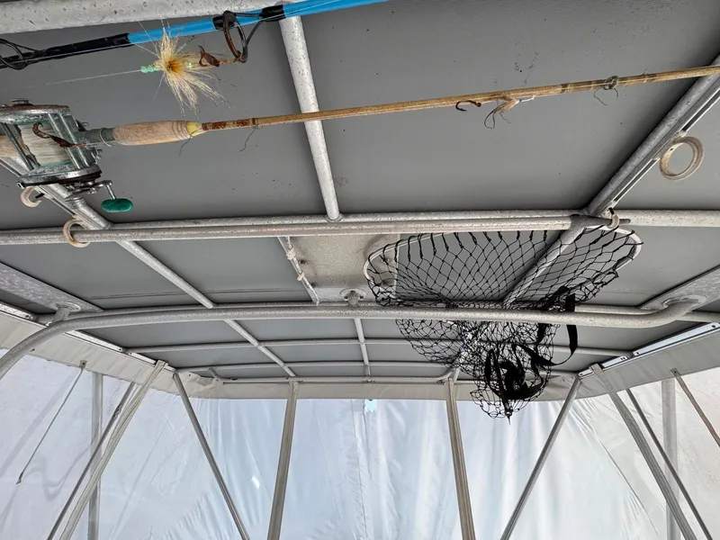 Slide: The Image of Interior view of a 1999 Luhrs 360 Convertible boat with fishing gear. - 7