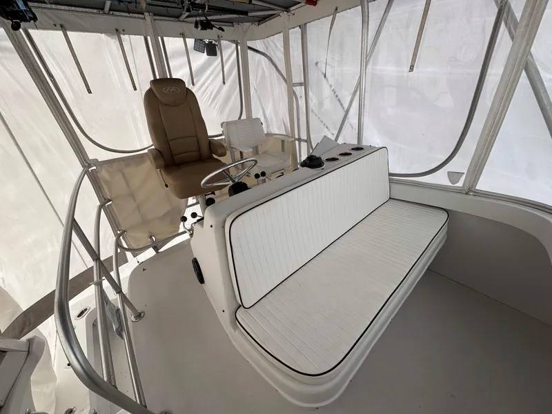 Slide: The Image of 1999 Luhrs 360 Convertible boat interior with helm and seating area. - 8
