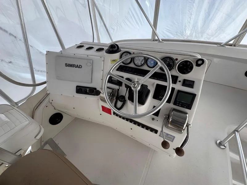Slide: The Image of 1999 Luhrs 360 Convertible boat helm with steering wheel and navigation instruments. - 9