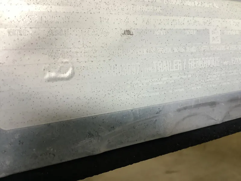 Slide: The Image of Close-up of a faded label on a 1997 Sea Ray 210 Open Bow boat. - 13