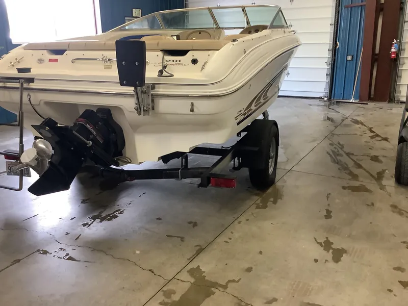 Slide: The Image of 1997 Sea Ray 210 Open Bow boat on trailer in indoor storage. - 4