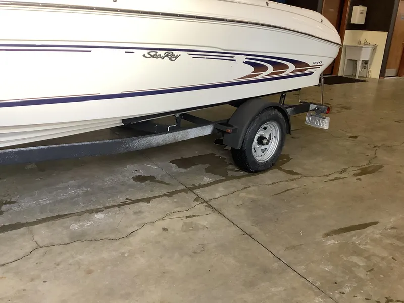 Slide: The Image of 1997 Sea Ray 210 Open Bow boat on trailer in garage setting. - 5