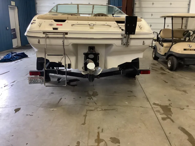 Slide: The Image of 1997 Sea Ray 210 Open Bow boat on trailer in garage. - 6