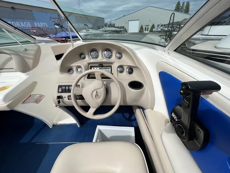 Slide: The Image of 1997 Sea Ray 210 Open Bow boat dashboard with steering wheel and control panel. - 9
