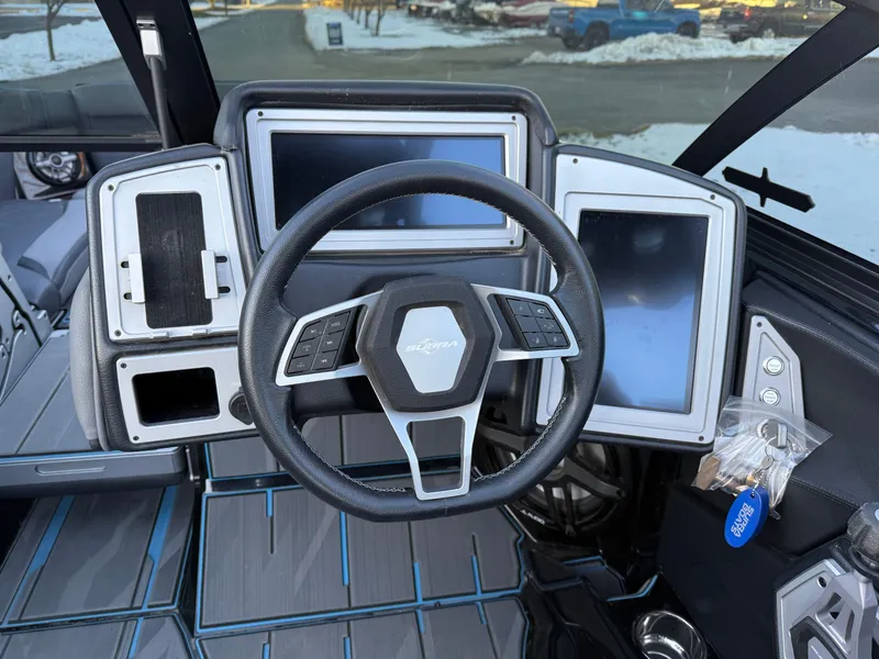 Slide: The Image of 2022 Supra SL boat dashboard with steering wheel and digital displays. - 10