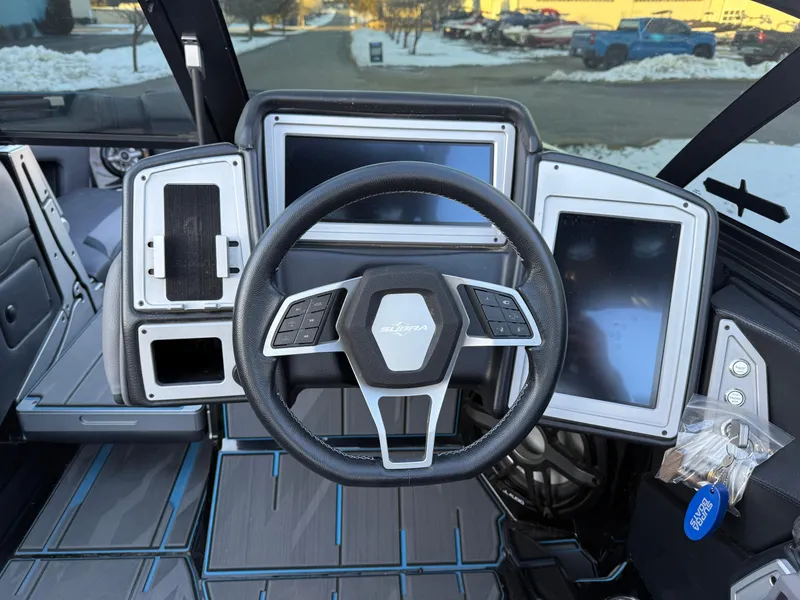 Slide: The Image of 2022 Supra SL boat dashboard with steering wheel and digital displays. - 11