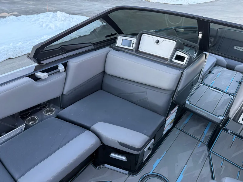 Slide: The Image of 2022 Supra SL boat interior with gray seating and modern dashboard. - 12