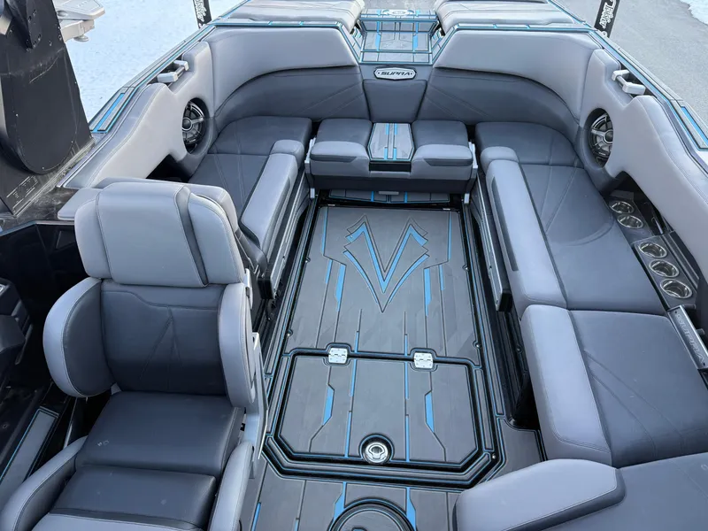 Slide: The Image of 2022 Supra SL boat interior with gray seating and blue-accented flooring. - 14