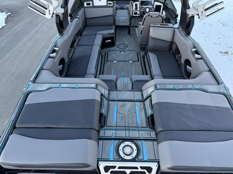 Slide: The Image of 2022 Supra SL boat interior with sleek gray seating and modern design. - 18