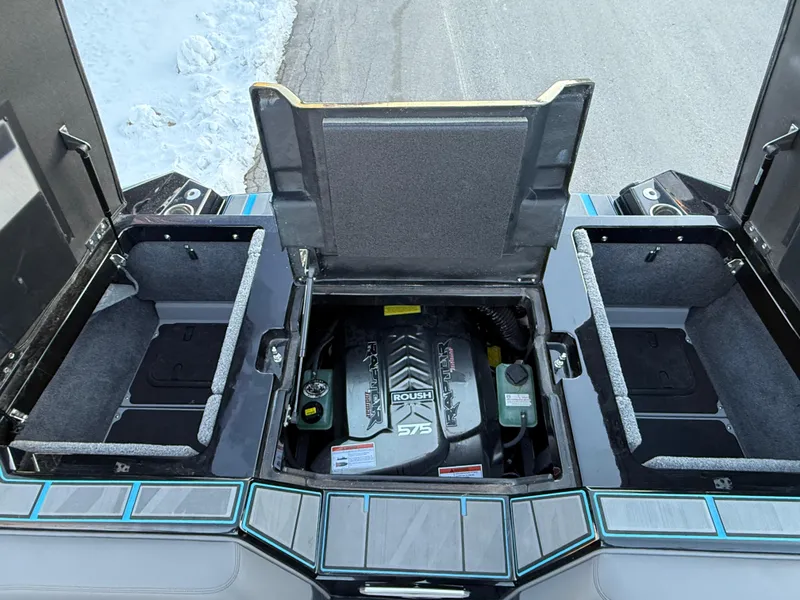 Slide: The Image of 2022 Supra SL boat engine compartment with Roush Raptor 575 engine, open storage areas. - 21