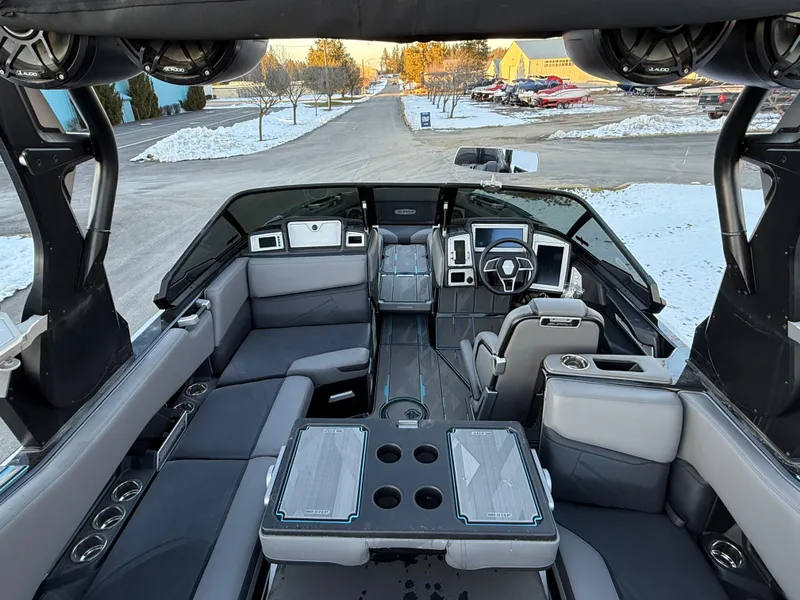 Slide: The Image of Interior of a 2022 Supra SL boat with modern seating and dashboard. - 24