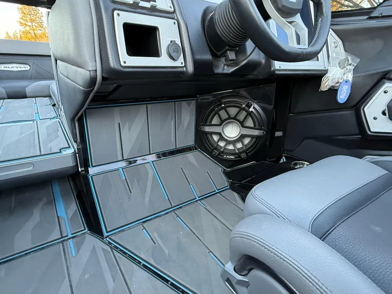 Slide: The Image of 2022 Supra SL interior with sleek design, featuring premium seating and advanced audio system. - 26