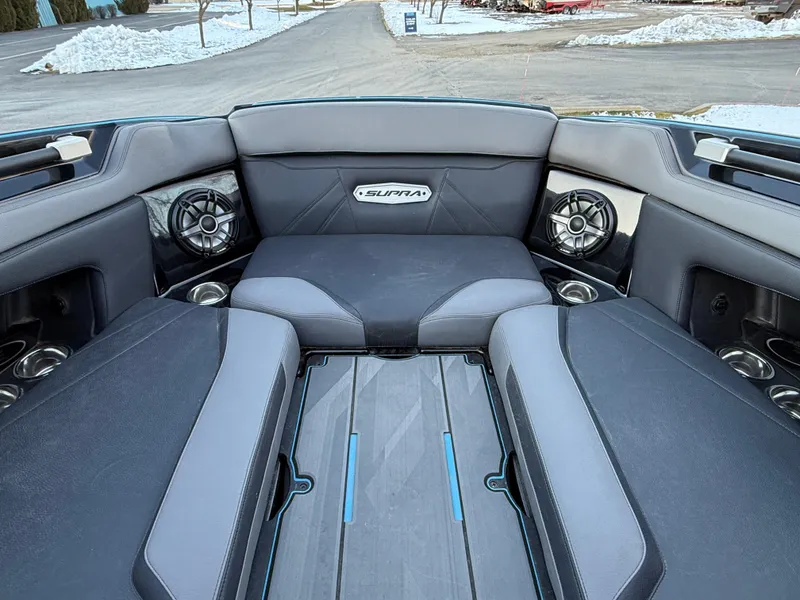 Slide: The Image of 2022 Supra SL boat interior with premium seating and speakers, set against a snowy backdrop. - 29