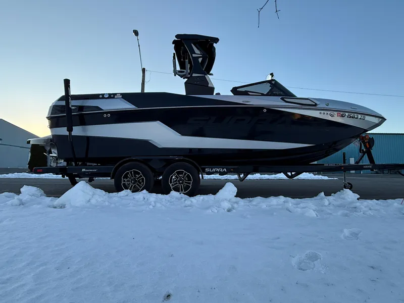 Slide: The Image of 2022 Supra SL boat on trailer in snowy setting. - 3