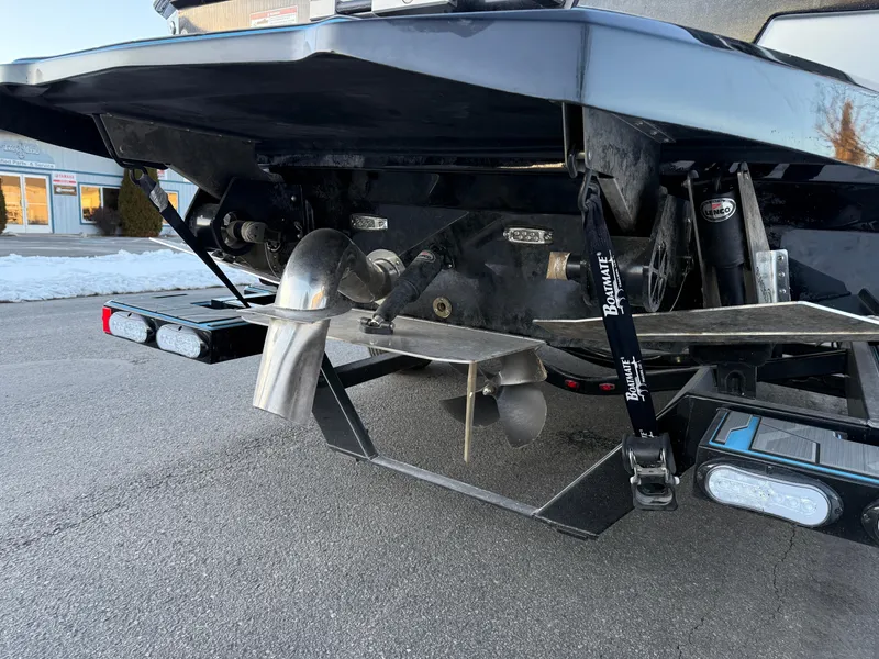 Slide: The Image of 2022 Supra SL boat rear view showing propeller and exhaust system. - 30