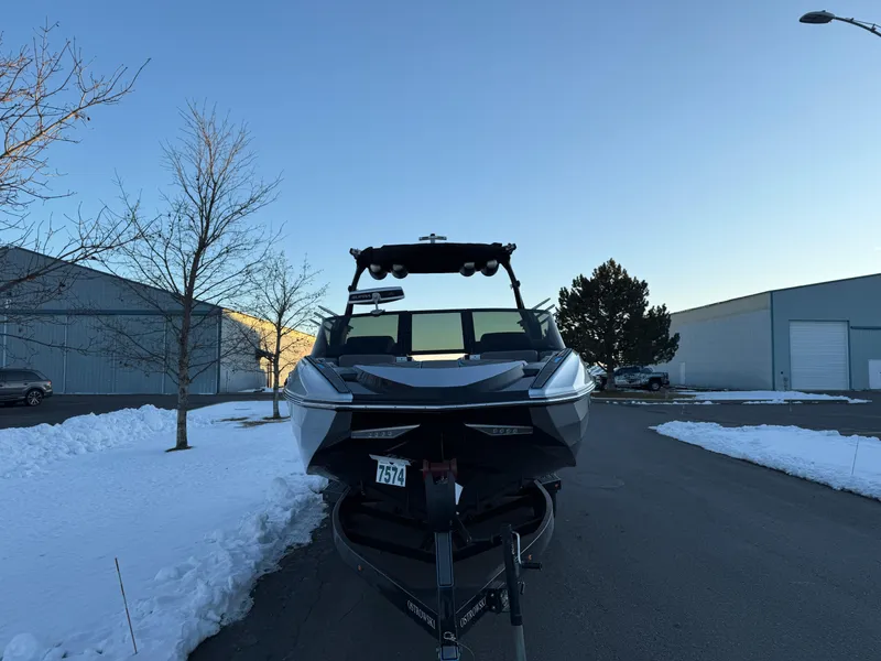 Slide: The Image of 2022 Supra SL boat on trailer in snowy parking lot. - 33