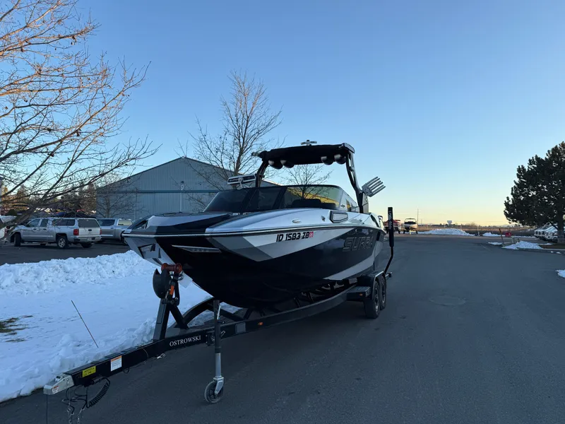 Slide: The Image of 2022 Supra SL boat on trailer in snowy parking lot. - 4